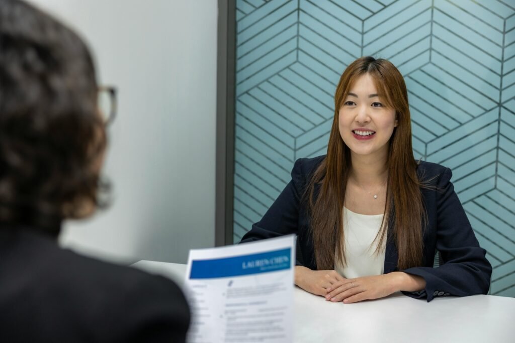 Why Job Boards and Legacy Outsourcing No Longer Scale? 13 Young woman in a business meeting with an interviewer, showcasing confidence and professionalism.